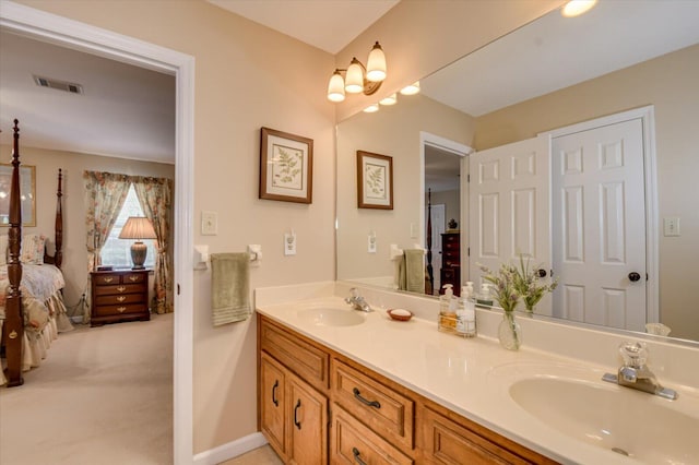 ensuite bathroom with ensuite bathroom, visible vents, a sink, and double vanity