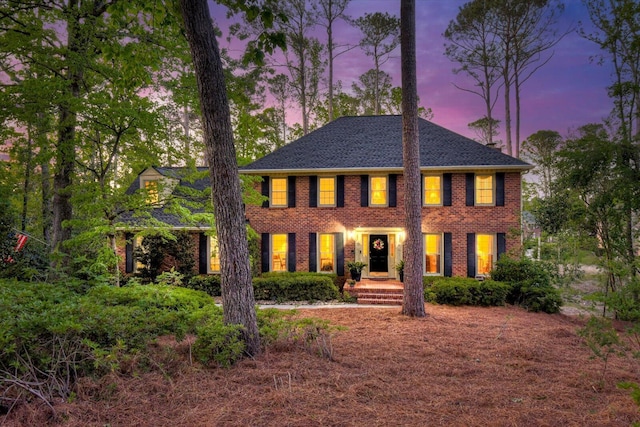 georgian-style home with brick siding