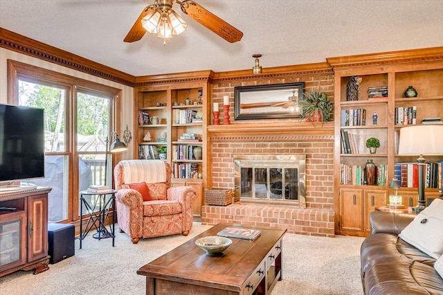 living area featuring carpet floors, a textured ceiling, ceiling fan, and crown molding