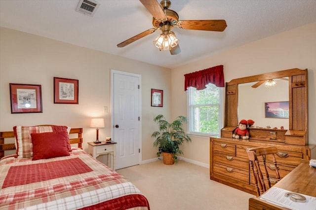 carpeted bedroom featuring visible vents, baseboards, and ceiling fan