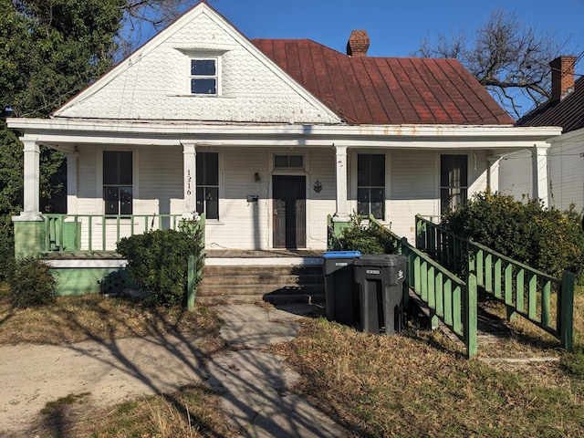 1316 Druid Park Ave, Augusta, GA 30904 - view of front of house with covered porch, a chimney, and a standing seam roof