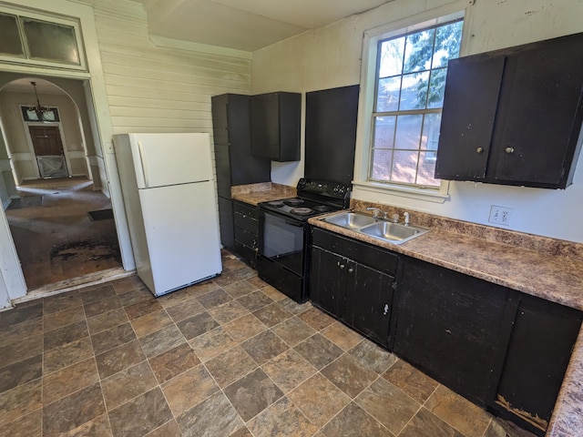 1316 Druid Park Ave, Augusta, GA 30904 - kitchen featuring black range with electric stovetop, freestanding refrigerator, a sink, dark cabinetry, and dark stone finish floors
