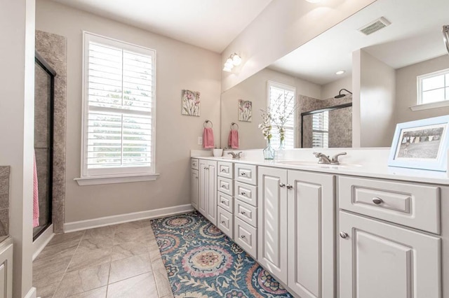 full bath featuring double vanity, visible vents, a sink, and a stall shower