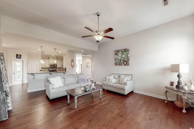 living room with visible vents, a ceiling fan, baseboards, and dark wood-style flooring