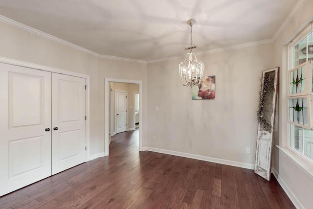 unfurnished dining area with baseboards, ornamental molding, dark wood-style flooring, and a chandelier