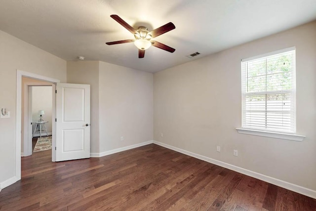 unfurnished room featuring ceiling fan, visible vents, and baseboards