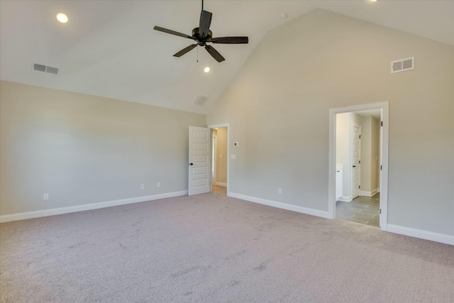 unfurnished bedroom featuring carpet floors, high vaulted ceiling, visible vents, and baseboards