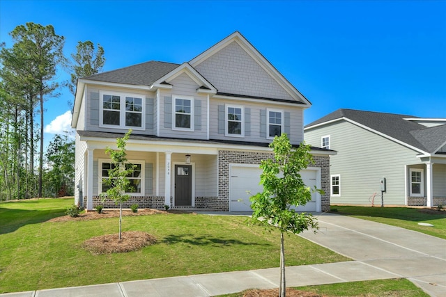 craftsman house with a front lawn, brick siding, a garage, covered porch, and driveway