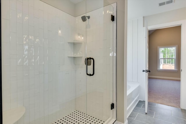full bathroom featuring a bath, visible vents, tile patterned flooring, and a stall shower