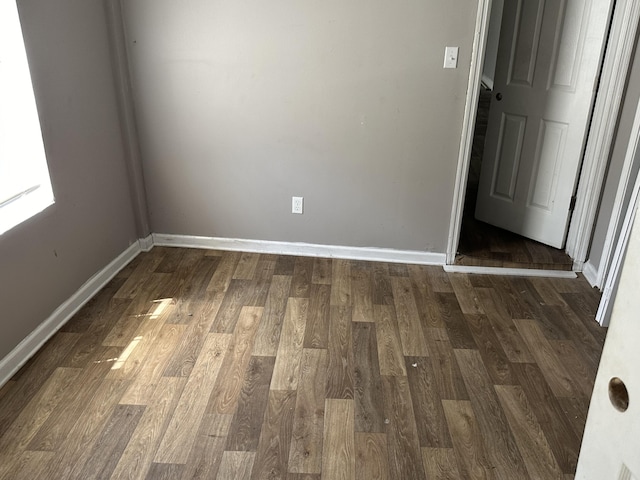 spare room with dark hardwood / wood-style flooring