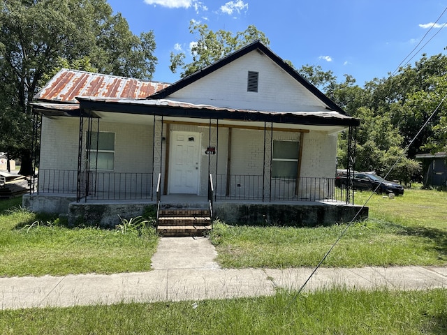 bungalow featuring a front yard and a porch