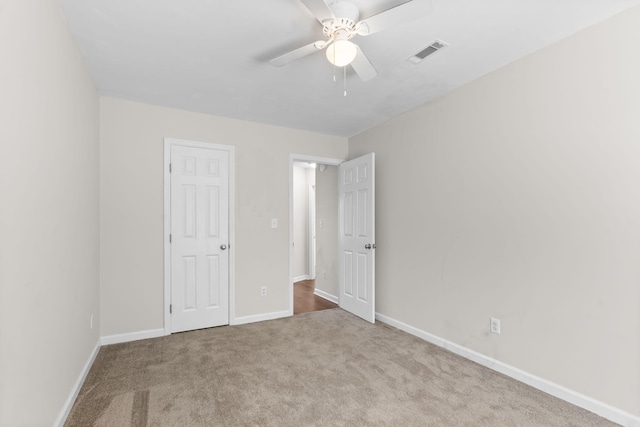 unfurnished bedroom with ceiling fan and light colored carpet