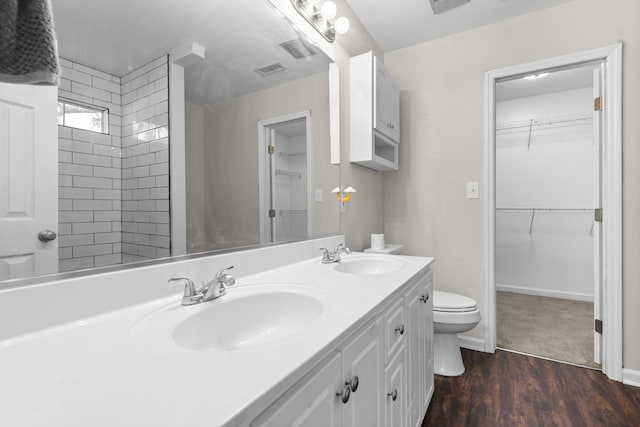 bathroom with vanity, toilet, a shower, and wood-type flooring