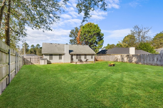 view of yard with an outdoor fire pit and a patio area