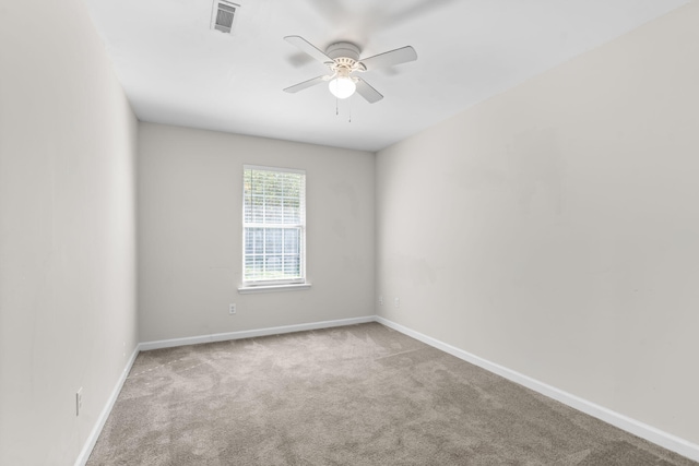 spare room featuring ceiling fan and light carpet