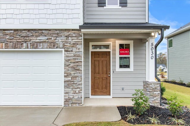 doorway to property with a garage