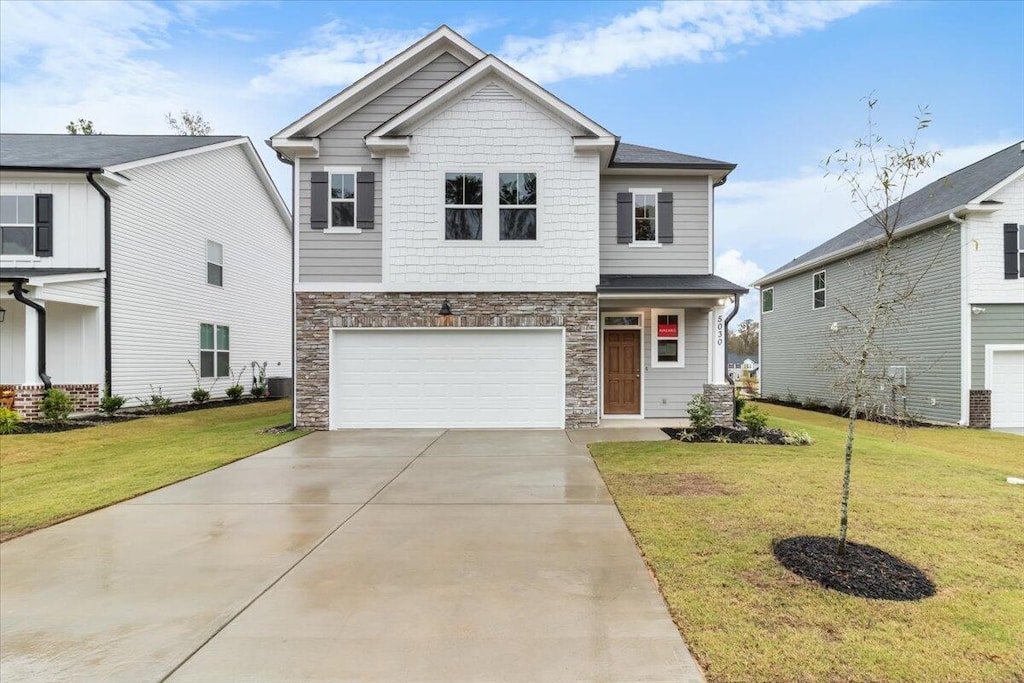 view of front of property featuring a garage and a front yard