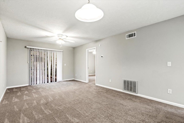 empty room with carpet flooring, a textured ceiling, and ceiling fan