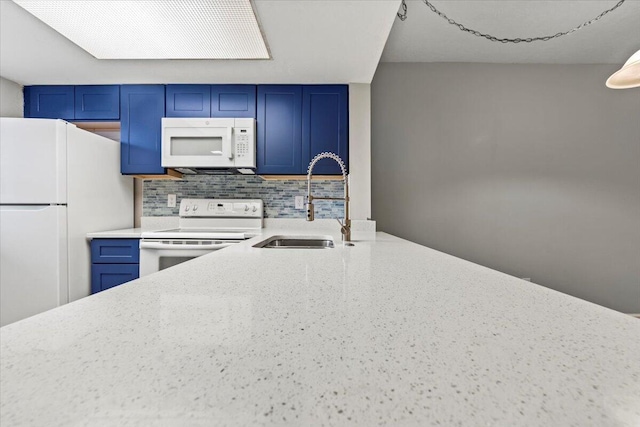 kitchen featuring backsplash, light stone counters, sink, and white appliances