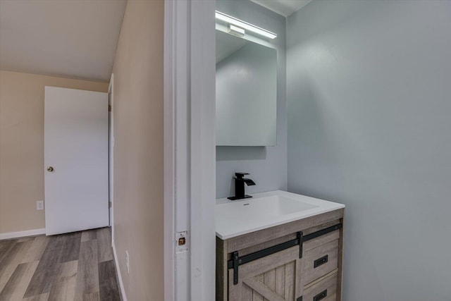 bathroom with vanity and hardwood / wood-style flooring