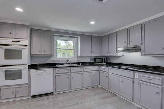 kitchen featuring white appliances, gray cabinets, and sink