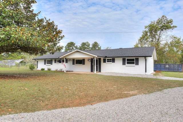 ranch-style home with a front lawn and covered porch