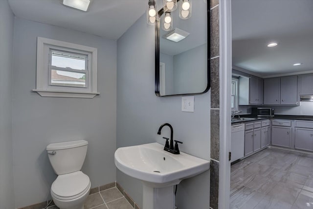 bathroom featuring tile patterned flooring, toilet, and sink