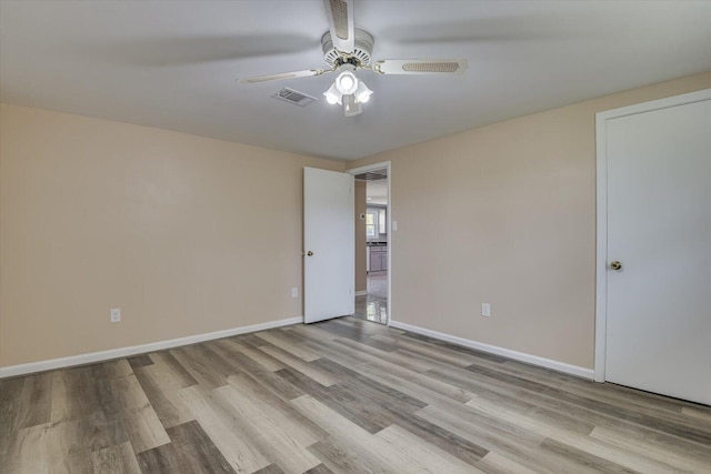 spare room with ceiling fan and light hardwood / wood-style flooring