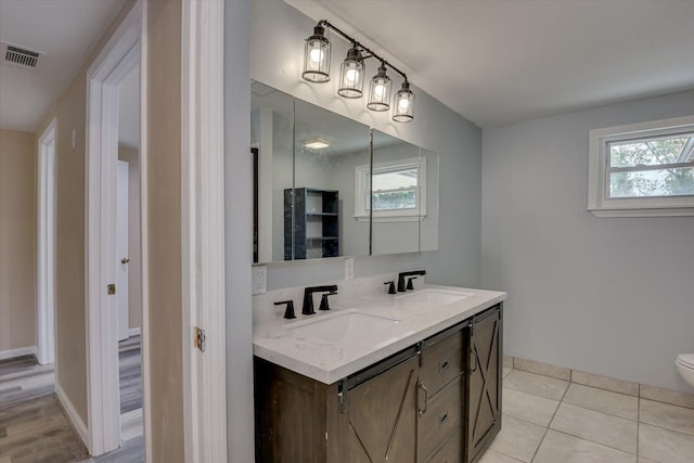 bathroom featuring tile patterned floors, vanity, and toilet