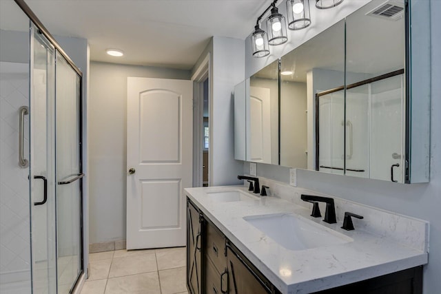 bathroom featuring tile patterned flooring, vanity, and an enclosed shower