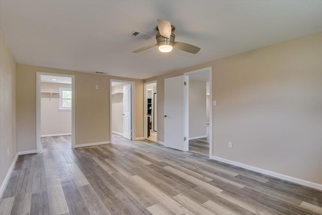 empty room featuring ceiling fan and light hardwood / wood-style floors