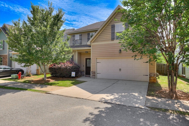 5558 Connor Dr, Evans, GA 30809 - view of front of house featuring stone siding, an attached garage, and concrete driveway