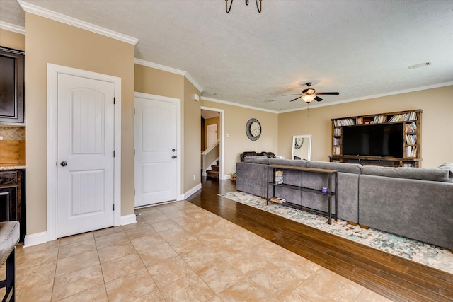 5558 Connor Dr, Evans, GA 30809 - living area featuring a ceiling fan, crown molding, stairs, and light wood finished floors
