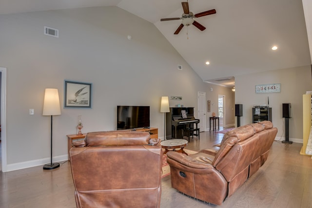 living room featuring high vaulted ceiling, visible vents, baseboards, a ceiling fan, and light wood-type flooring