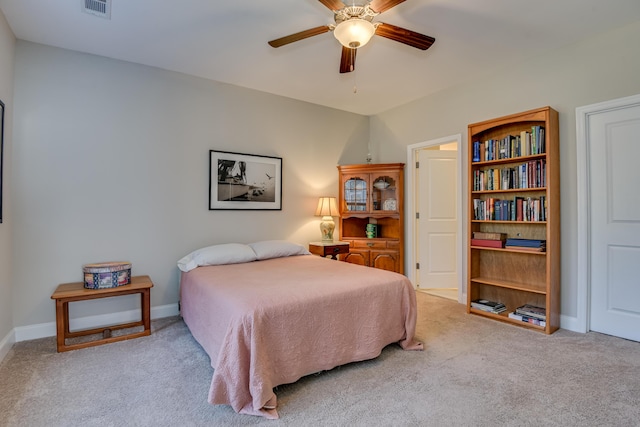 bedroom featuring light carpet, ceiling fan, visible vents, and baseboards