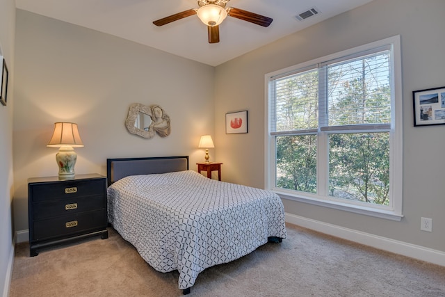 bedroom with baseboards, multiple windows, visible vents, and light colored carpet