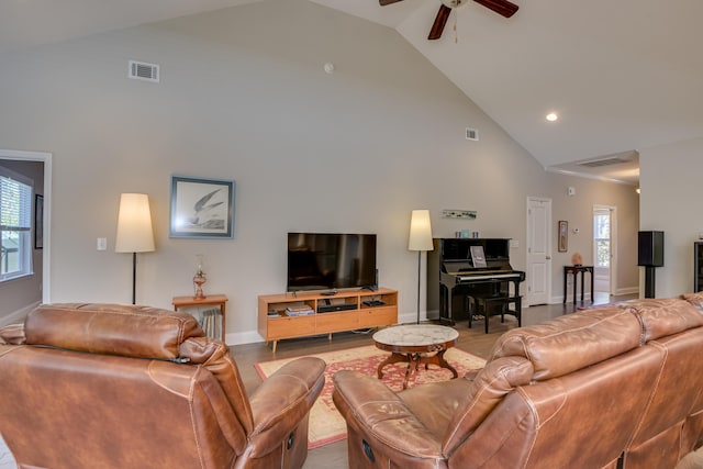 living area featuring high vaulted ceiling and visible vents