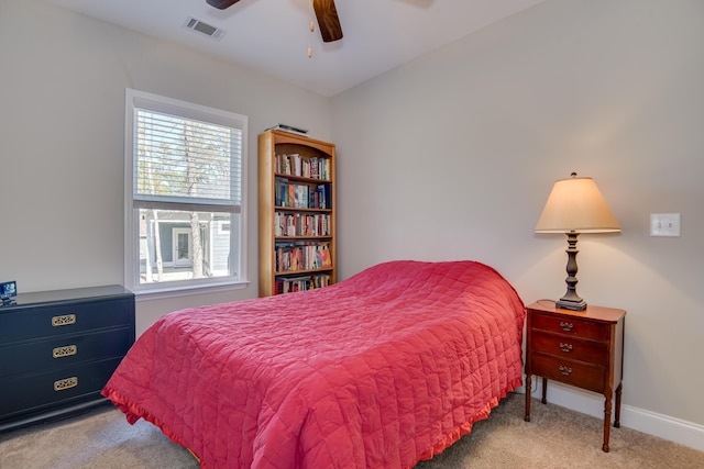 bedroom featuring a ceiling fan, light colored carpet, visible vents, and baseboards