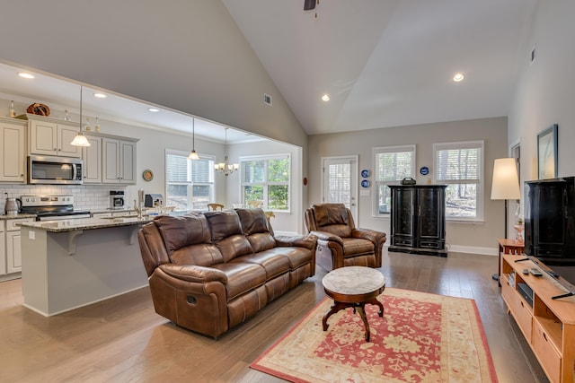 living area featuring light wood-style flooring, visible vents, a chandelier, and recessed lighting