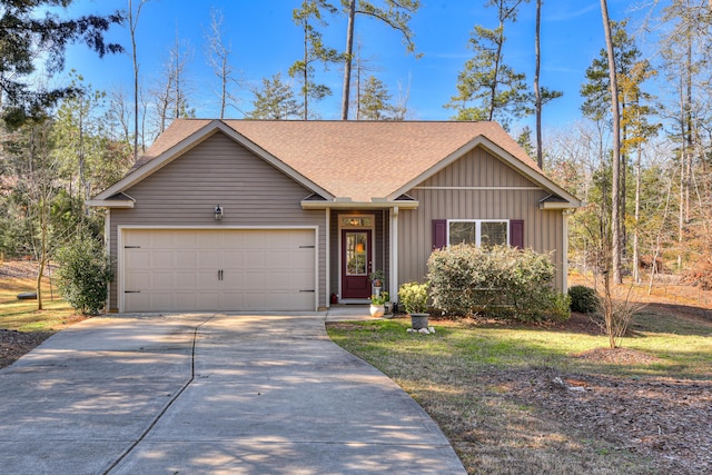 view of front of property with a garage, driveway, roof with shingles, a front lawn, and board and batten siding