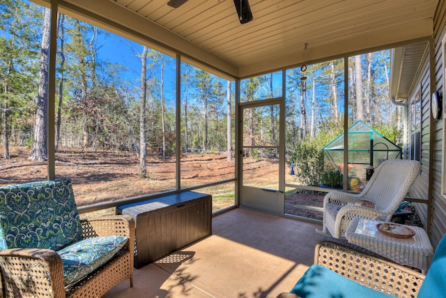 sunroom featuring ceiling fan and wood ceiling