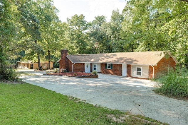 single story home with an outbuilding and a front lawn