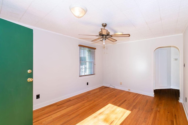 unfurnished room with wood-type flooring, ceiling fan, and ornamental molding