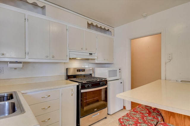 2125 Silverdale Rd, Augusta, GA 30906 - kitchen featuring gas stove, light countertops, white microwave, and under cabinet range hood