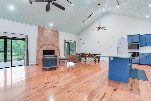 136 Lake Bluff Dr, Waynesboro, GA 30830 - living room with ceiling fan, light wood-style flooring, wood ceiling, high vaulted ceiling, and a brick fireplace