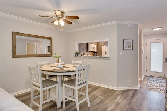 315 Coastal Cv, Mccormick, SC 29835 - dining area with a ceiling fan, wood finished floors, crown molding, and baseboards