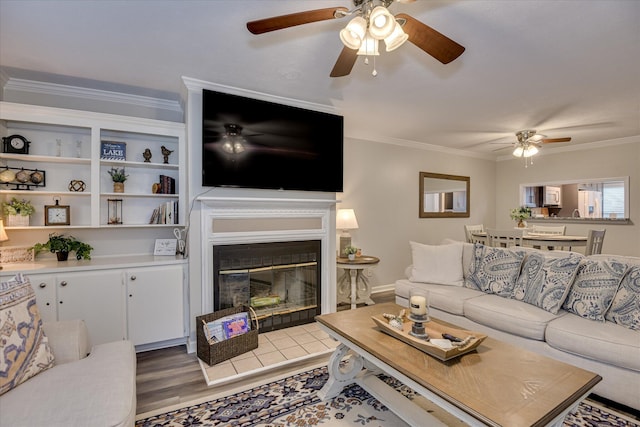 315 Coastal Cv, Mccormick, SC 29835 - living area featuring a ceiling fan, crown molding, light wood-style flooring, and a glass covered fireplace