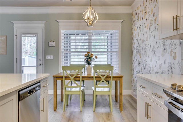 kitchen featuring white cabinetry, decorative light fixtures, ornamental molding, dishwasher, and a wealth of natural light