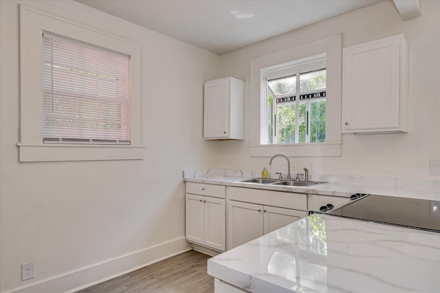 1847 Warren St, Augusta, GA 30904 - kitchen with a sink, baseboards, light wood-type flooring, and white cabinetry
