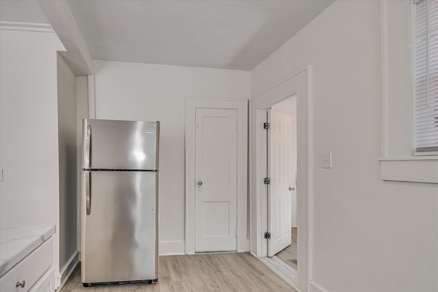 1847 Warren St, Augusta, GA 30904 - kitchen featuring light wood-style floors, freestanding refrigerator, baseboards, and light stone counters